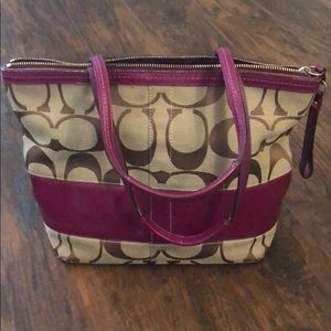 Coach bag with berry purple detailing.